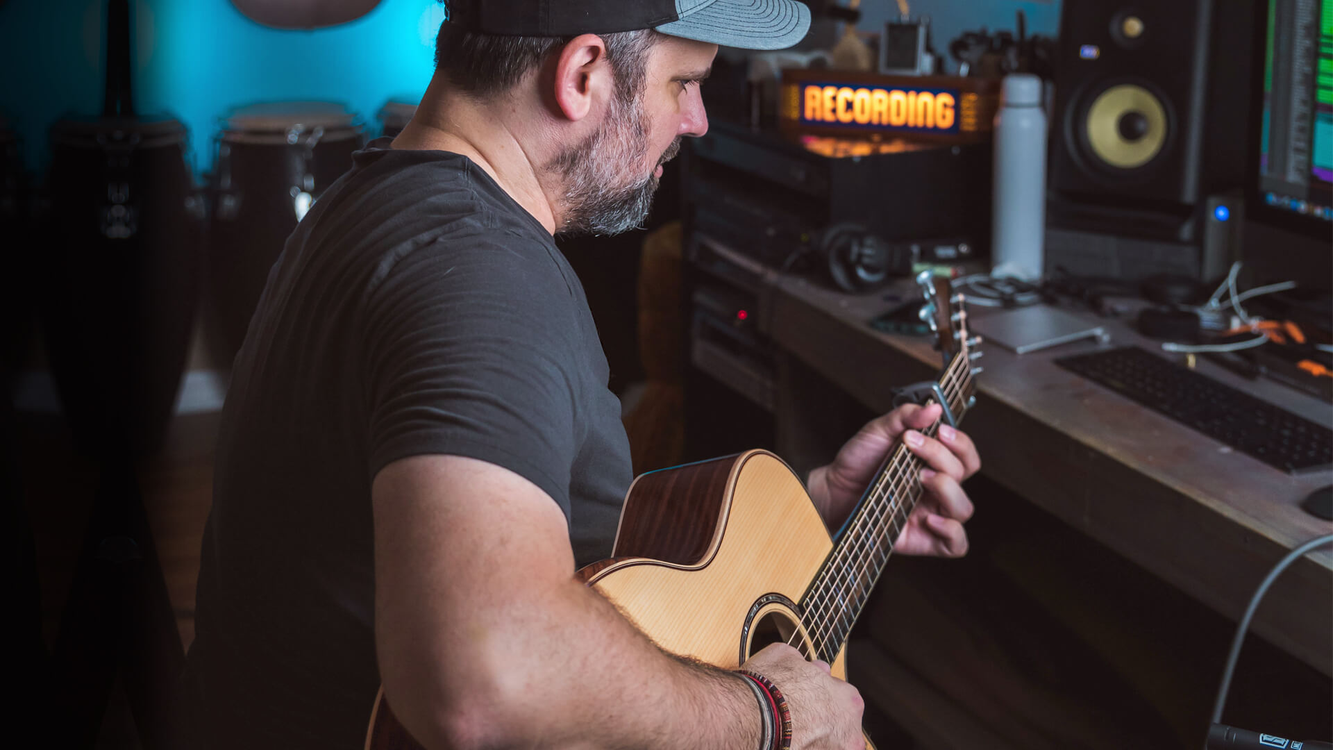 Gabriel O'Brien plays his Taylor guitar at his home recording studio