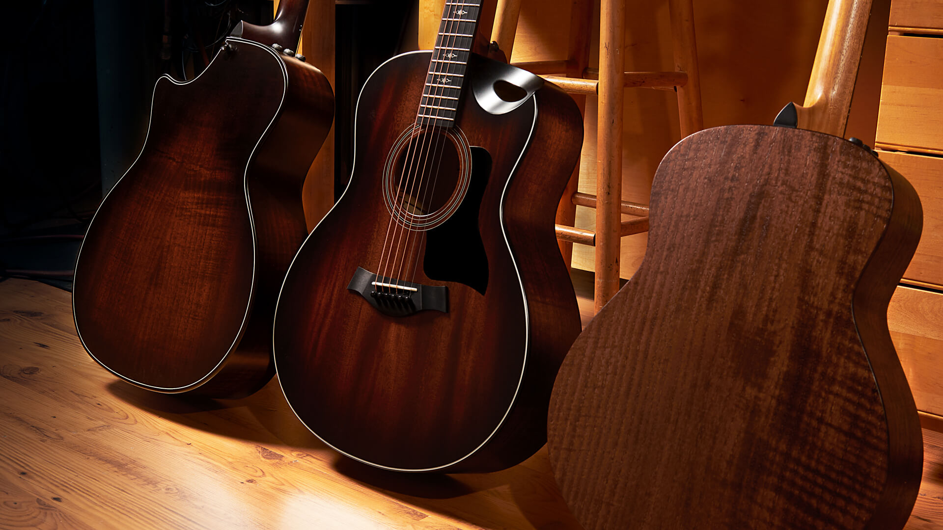 three Taylor acoustic guitars