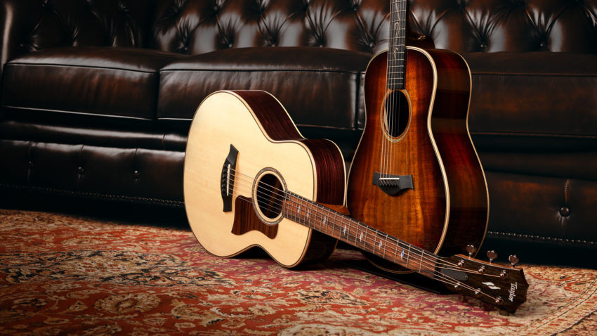 two Taylor GT acoustic guitars - one natural finish and one sunburst finish