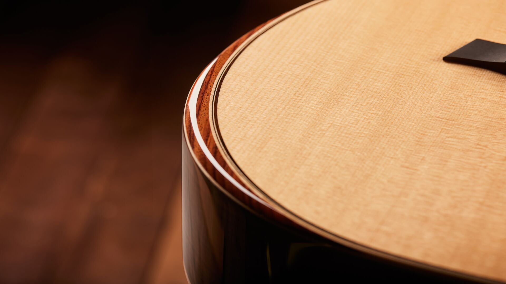 photo of Taylor 800 series acoustic guitar close-up on armrest feature